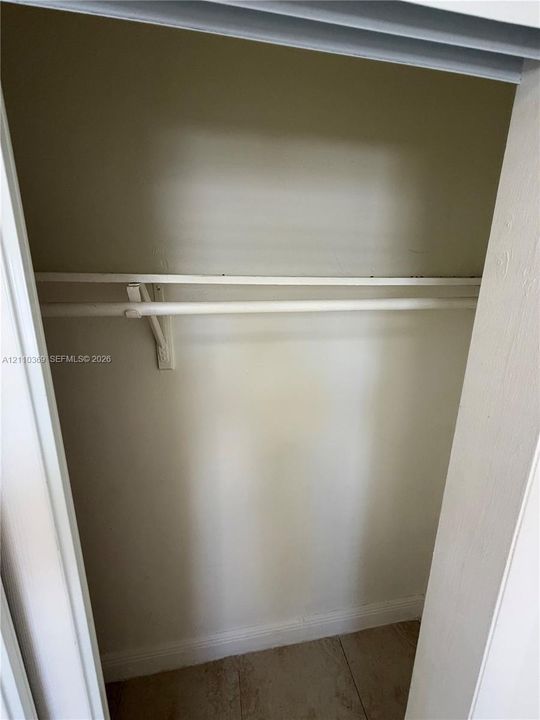 Closet featuring neutral wall finishes and a built-in hanging rod