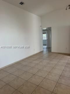 Vaulted ceilings and neutral ceramic tile flooring