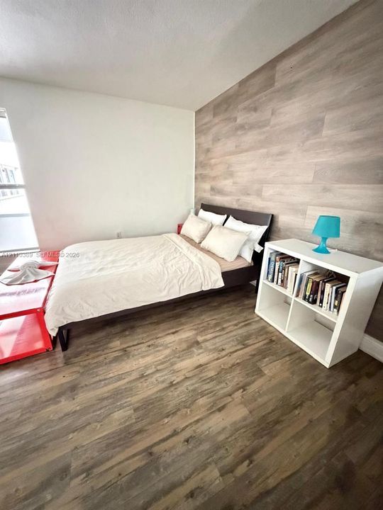 Wood-finish flooring and a decorative wood-finish plank accent wall
