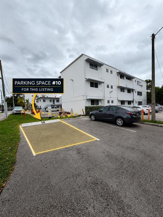 Designated parking space number 10 featuring asphalt surfacing and concrete bumper