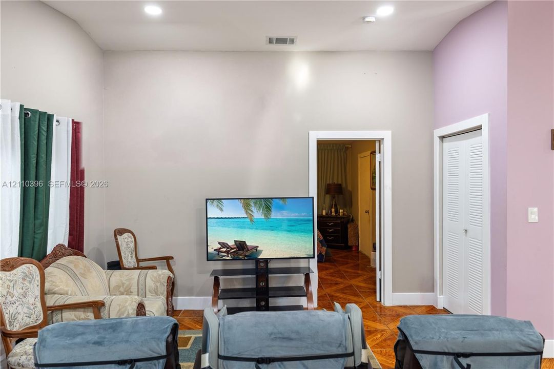 High ceilings featuring recessed lighting, diamond-patterned tile flooring, and louvered closet doors