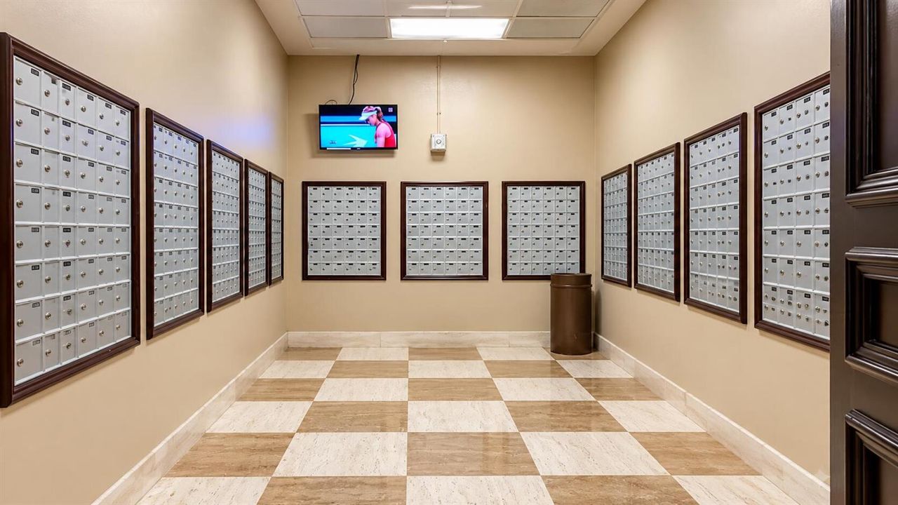 Bright Apartment Mailroom with Sports TV