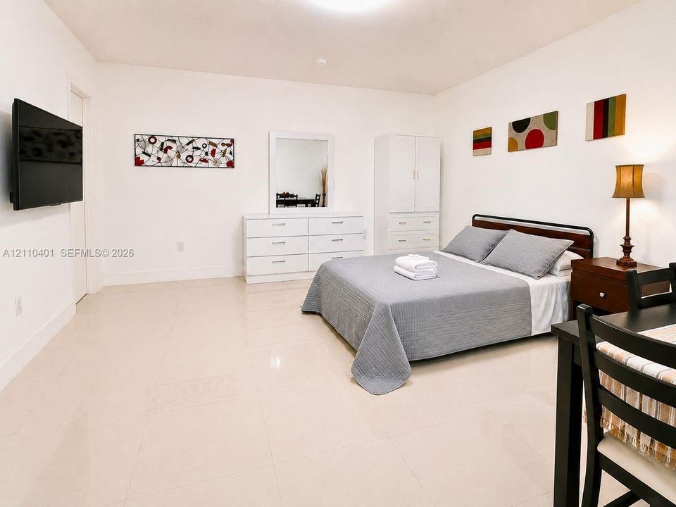 Spacious interior featuring large-format ceramic tile flooring and smooth, neutral-painted wall surfaces
