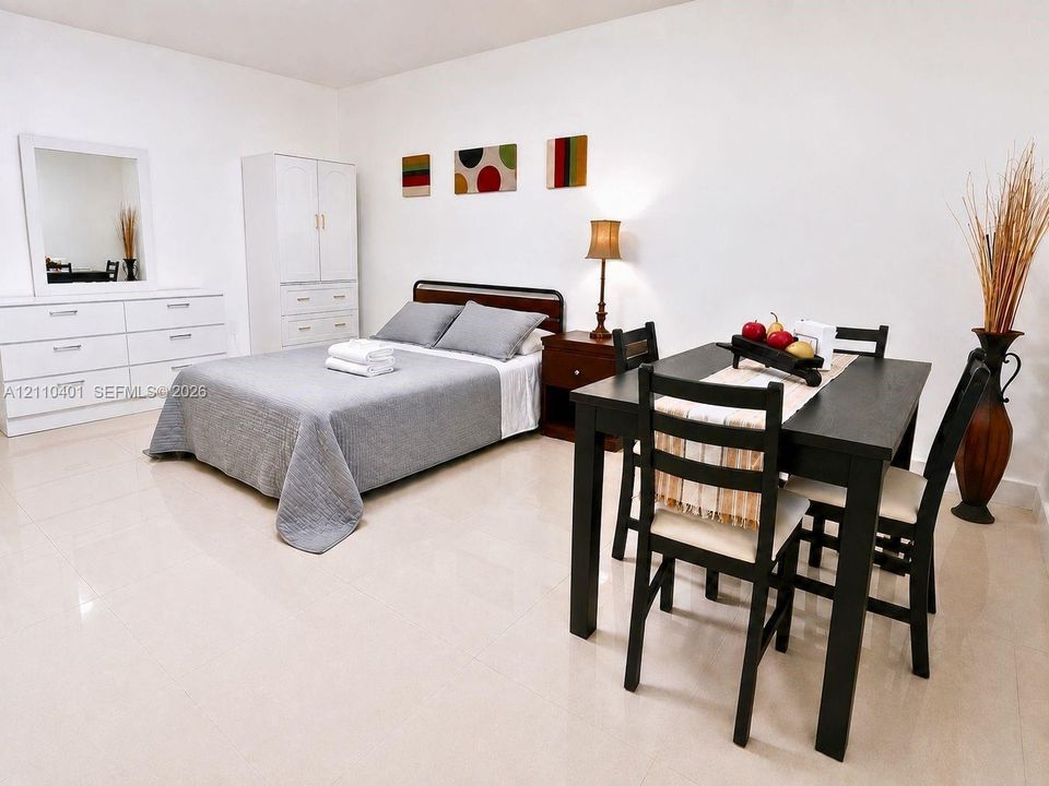 Neutral interior space featuring polished tile flooring and white walls