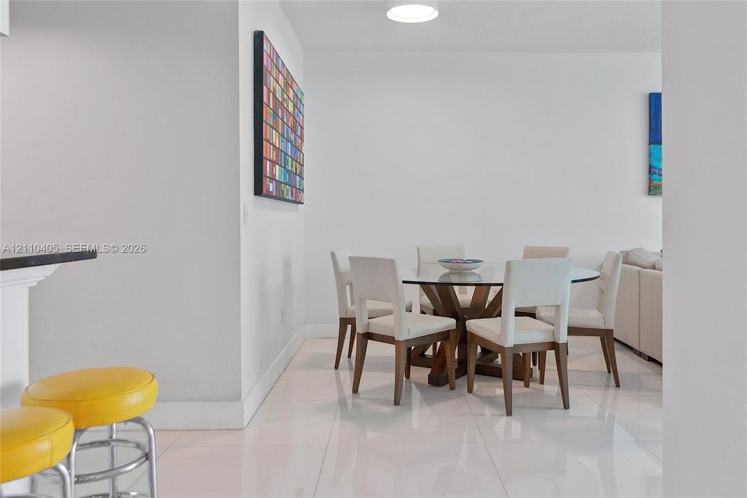 Glossy tile flooring, neutral wall finishes, and recessed ceiling lighting