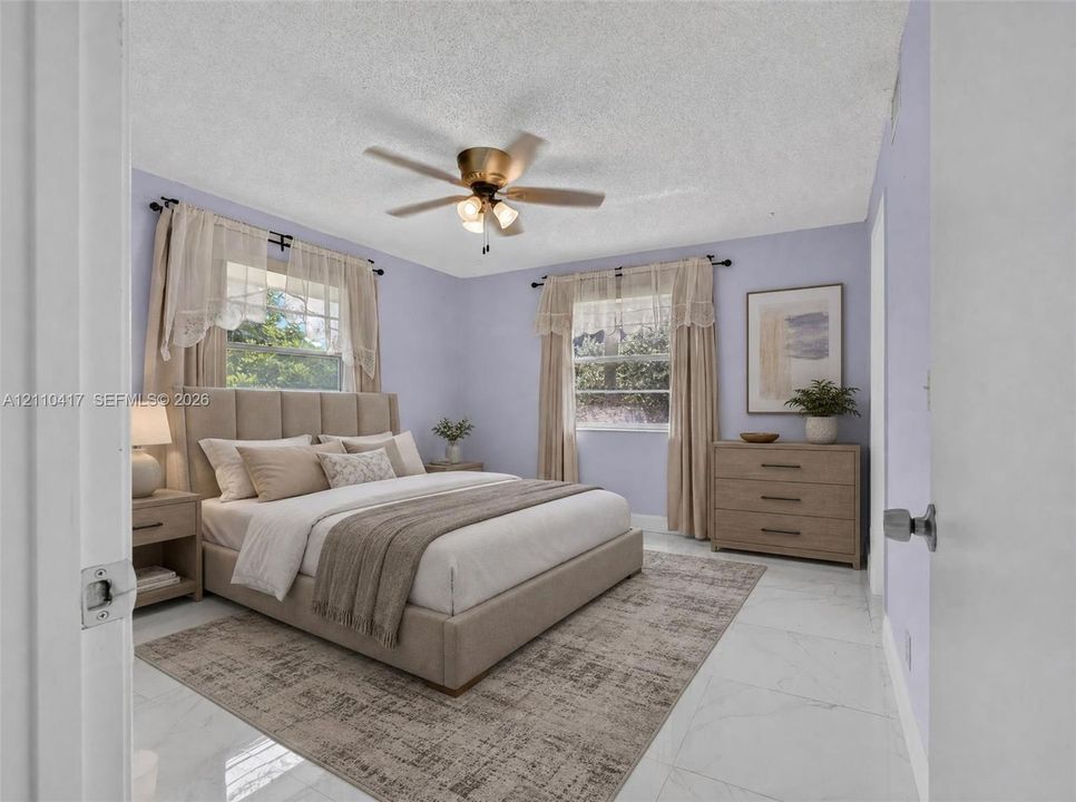 Bedroom featuring polished stone-finish flooring and a central ceiling fan with integrated lighting