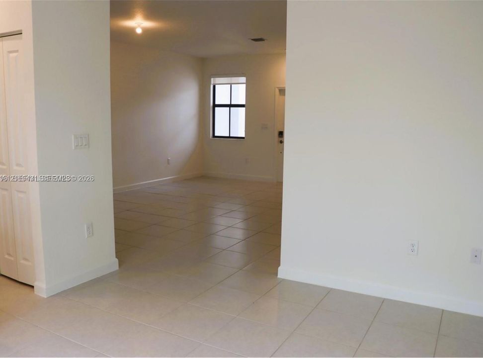 Neutral-toned ceramic tile flooring, interior closet with bi-fold doors, and recessed ceiling lighting