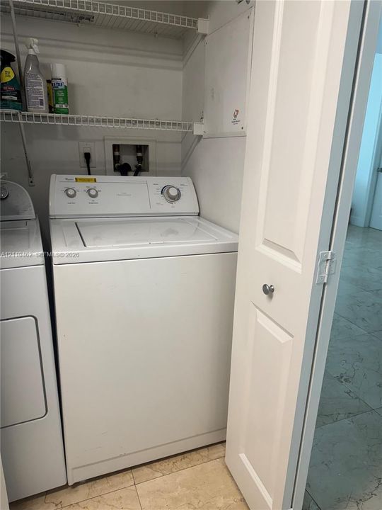 Laundry closet featuring wire shelving and bifold doors