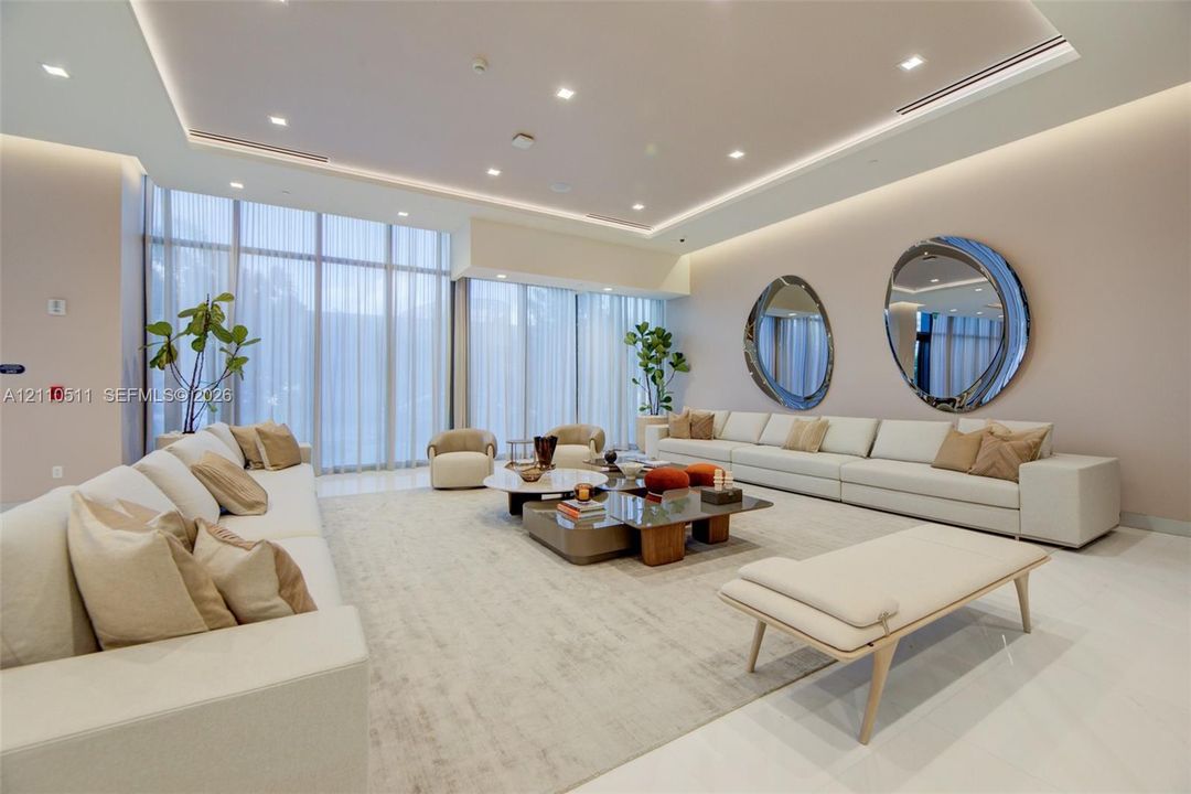 Banquet Hall, floor-to-ceiling windows with integrated recessed tray ceiling lighting, cove illumination, and polished stone flooring