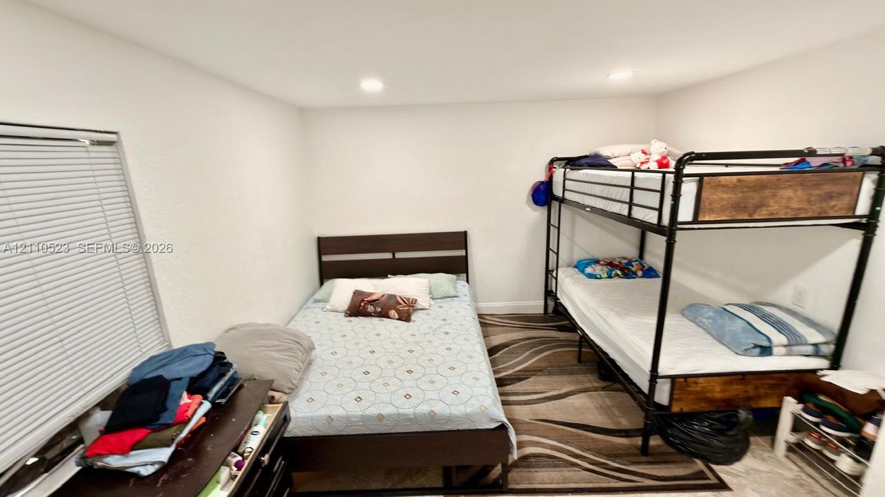 Interior room featuring neutral wall paint, recessed lighting, and horizontal window blinds