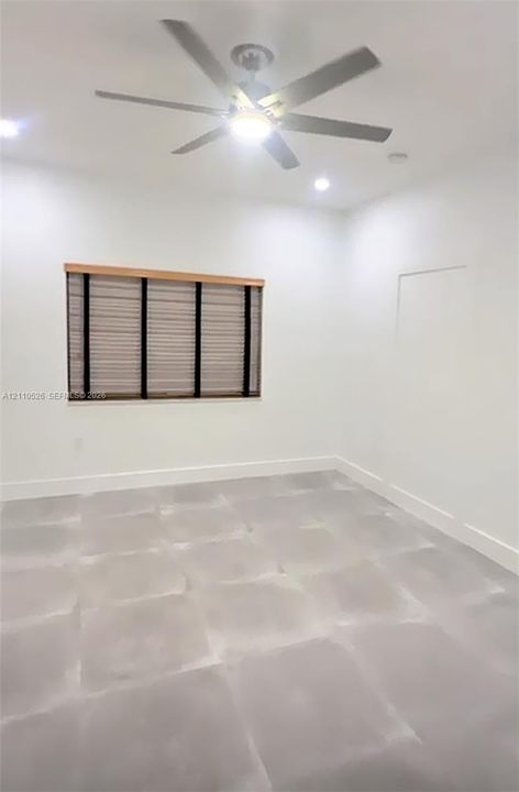Neutral-toned tile flooring, recessed ceiling lighting, and a multi-blade ceiling fan featuring an integrated light fixture