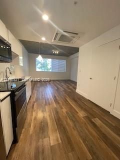 Kitchen featuring white cabinetry, wood-finish flooring, recessed lighting, and a neutral color palette