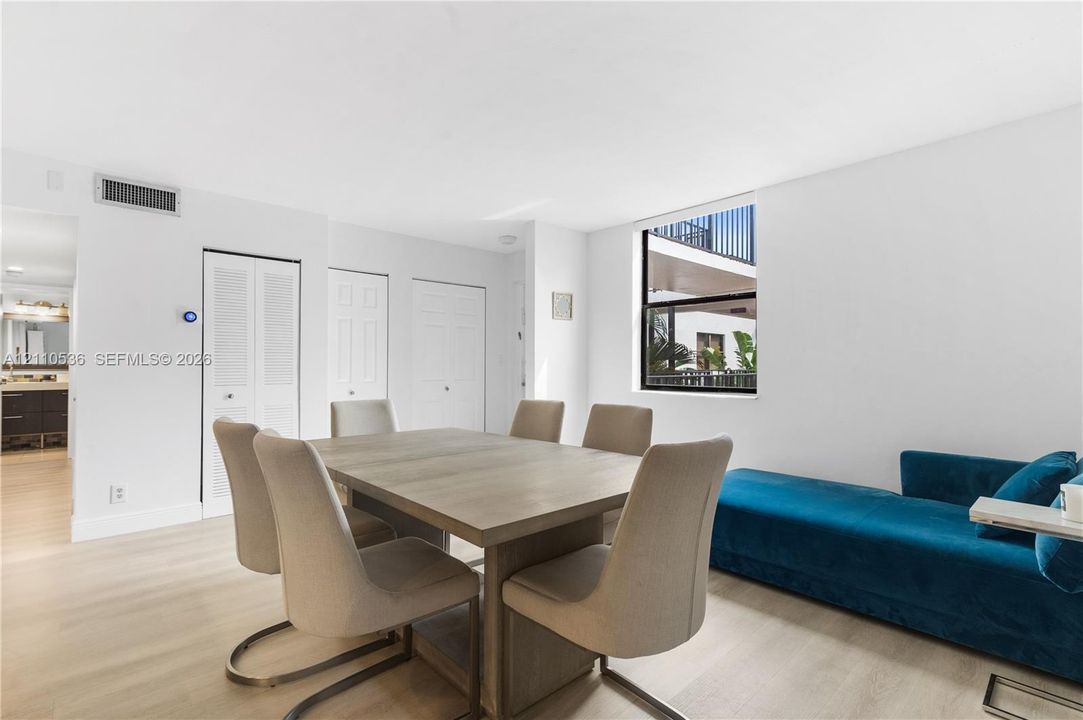 Neutral interior featuring light wood-finish flooring, recessed lighting, and a square window