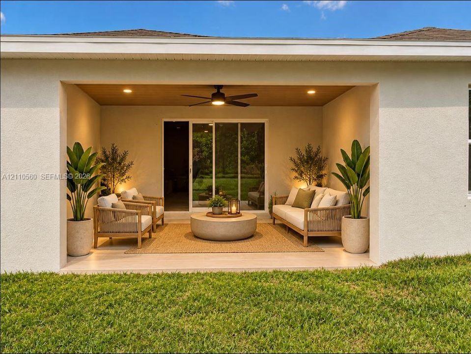 Covered rear patio featuring a wood-tone paneled ceiling, recessed lighting, ceiling fan, and sliding glass door