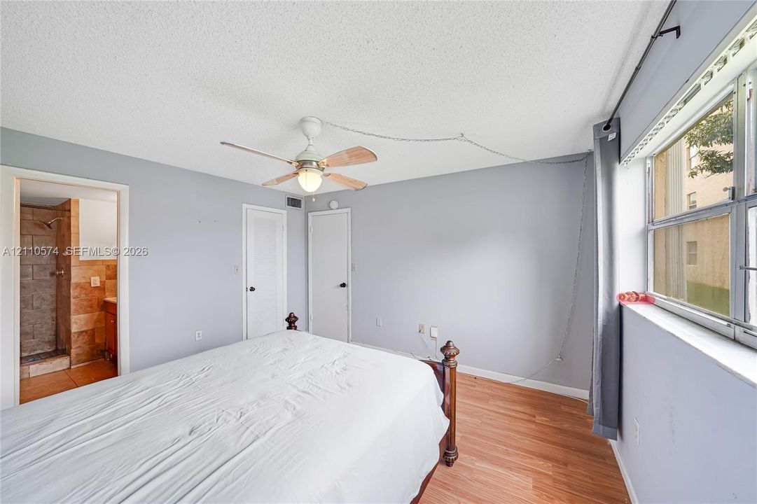 Wood-finish flooring, ceiling fan with integrated lighting, and horizontal sliding windows