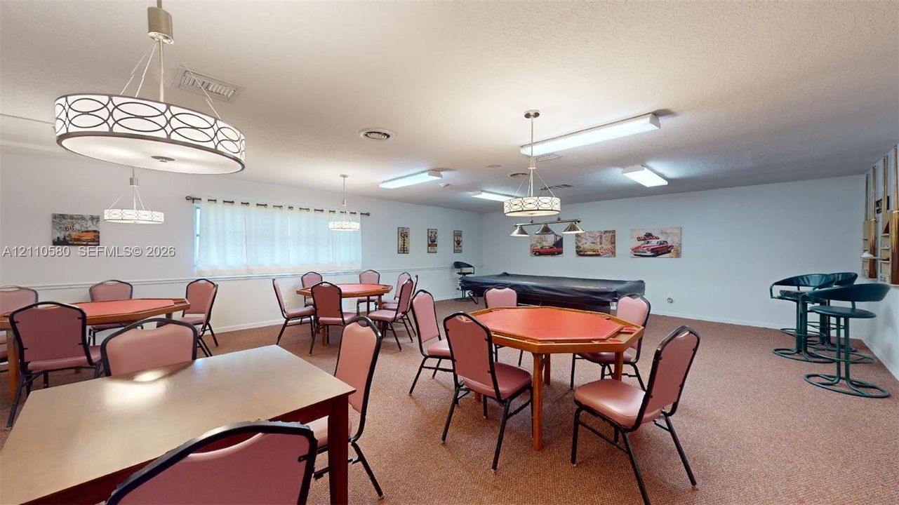 Large interior space featuring multi-tiered drum pendant lighting, linear recessed lighting, and wall-mounted chair rail molding