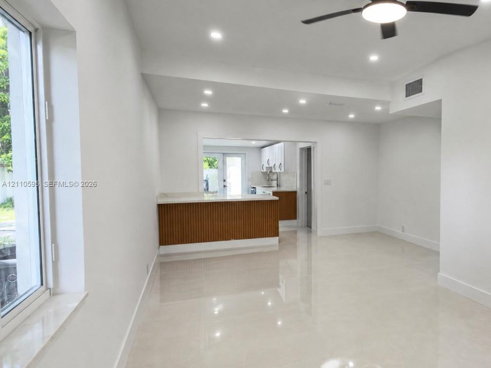 Polished tile flooring, recessed lighting, and a modern ceiling fan with integrated lighting