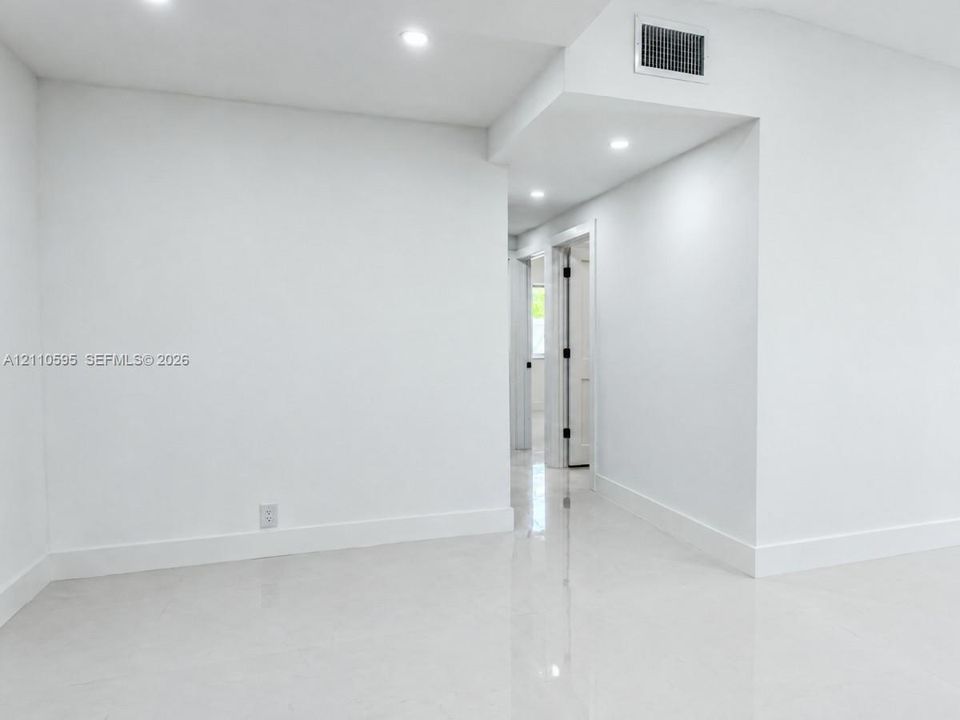 Interior space featuring recessed LED lighting and polished stone-finish flooring