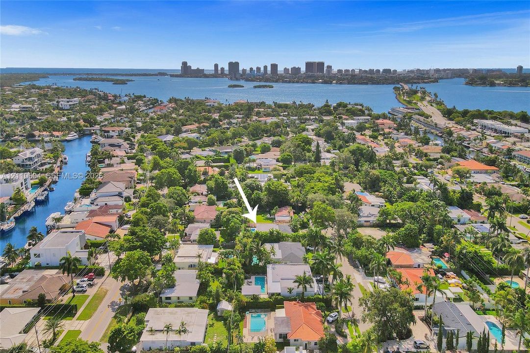 Aerial perspective highlighting residential property featuring a backyard swimming pool and mature landscaping
