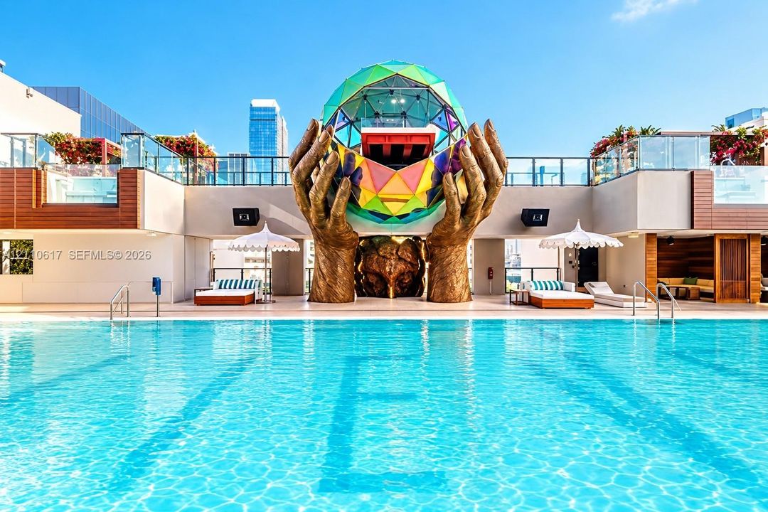 Rooftop swimming pool featuring a geometric glass dome sculpture, integrated bronze-finished hand statues, wood-panel siding, and glass railings