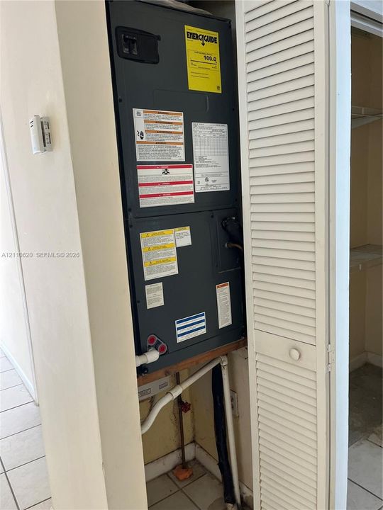 Dedicated closet housing an HVAC unit with louvered door access