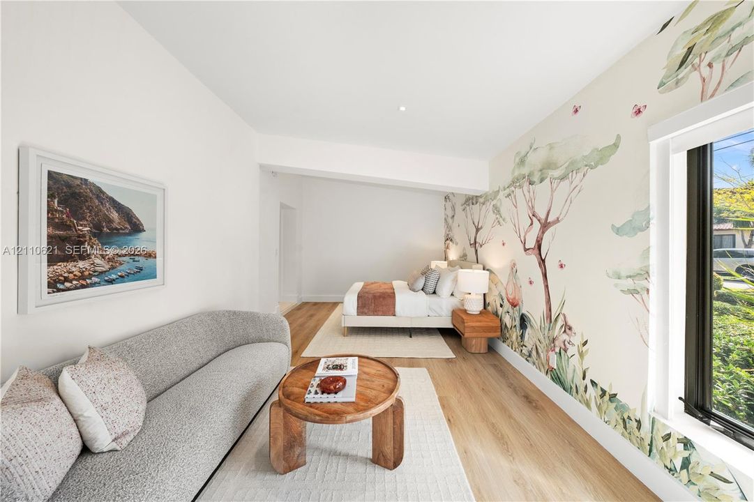 Large-scale illustrative wall mural, wood-finish flooring, and recessed ceiling lighting