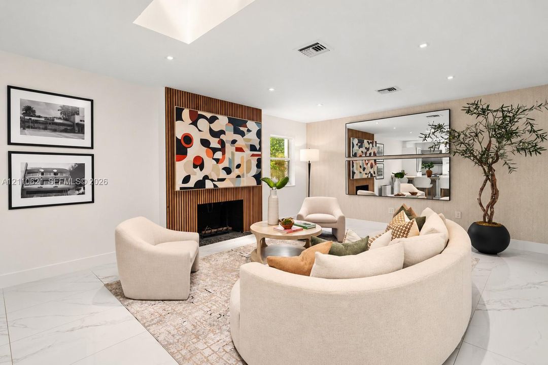 Interior space featuring large-format tile flooring, a fireplace surround with vertical wood slat paneling, a recessed skylight, recessed lighting, and textured wall covering