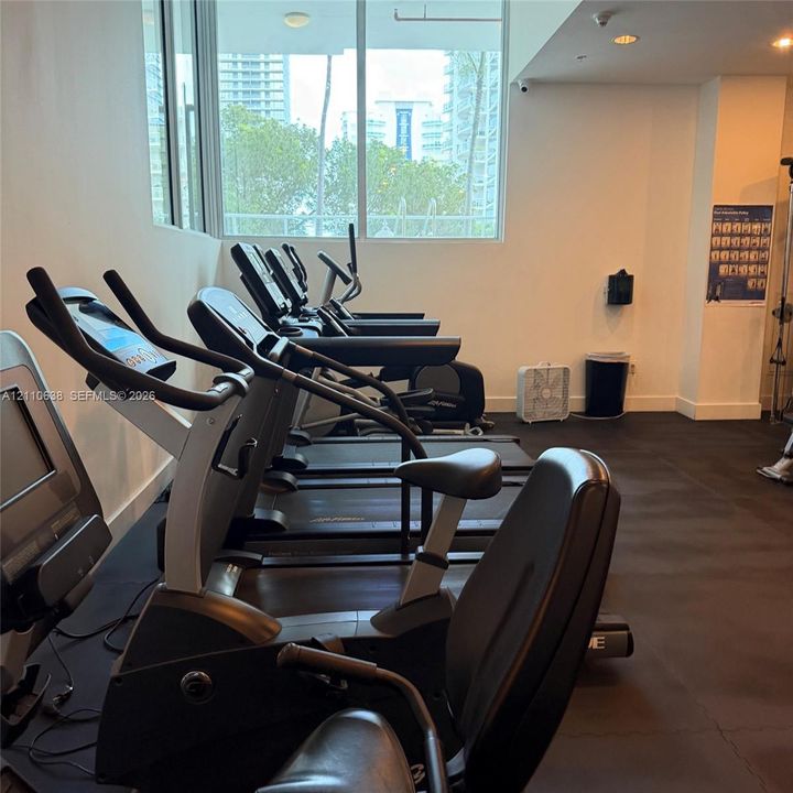 Fitness facility featuring rubberized flooring and expansive floor-to-ceiling windows