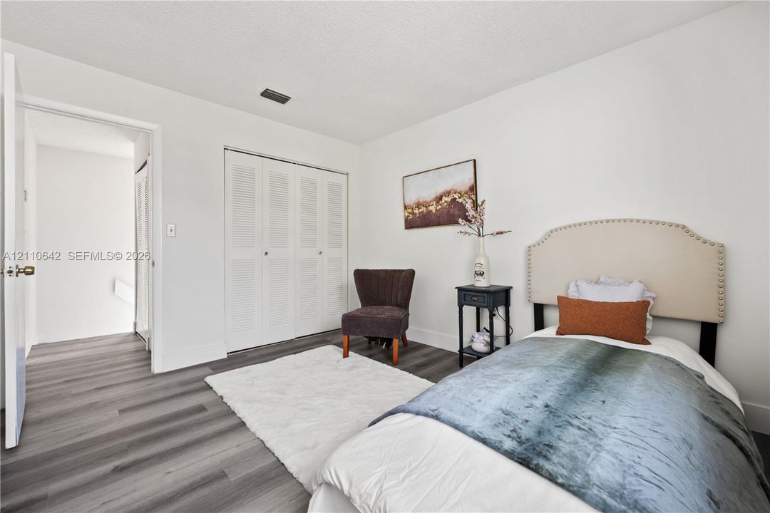Wood-finish flooring and closet with louvered double doors
