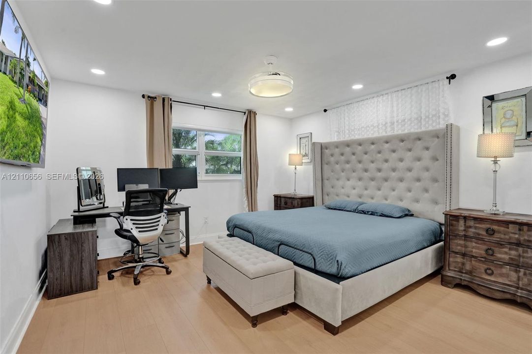 Recessed lighting, wood-finish flooring, and a multi-pane window