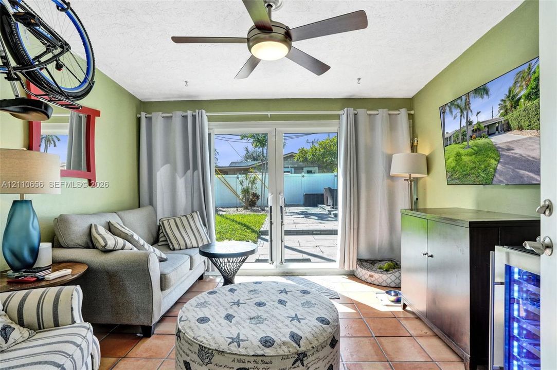 Tile flooring, multi-pane glass French doors, and ceiling fan with integrated lighting