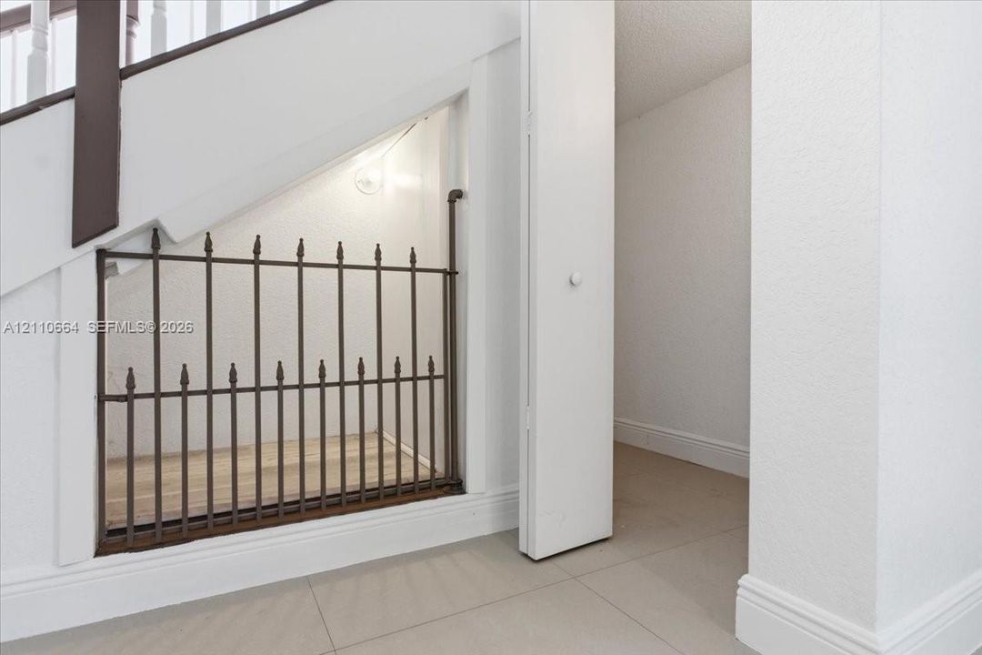 Thoughtful under-stair pet nook complemented by additional storage space