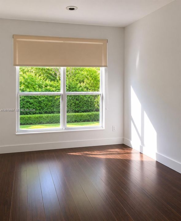 Dark wood-finish flooring and dual-pane window featuring exterior landscaping