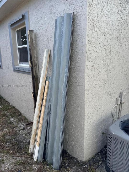 Exterior wall featuring stucco finish and a framed window