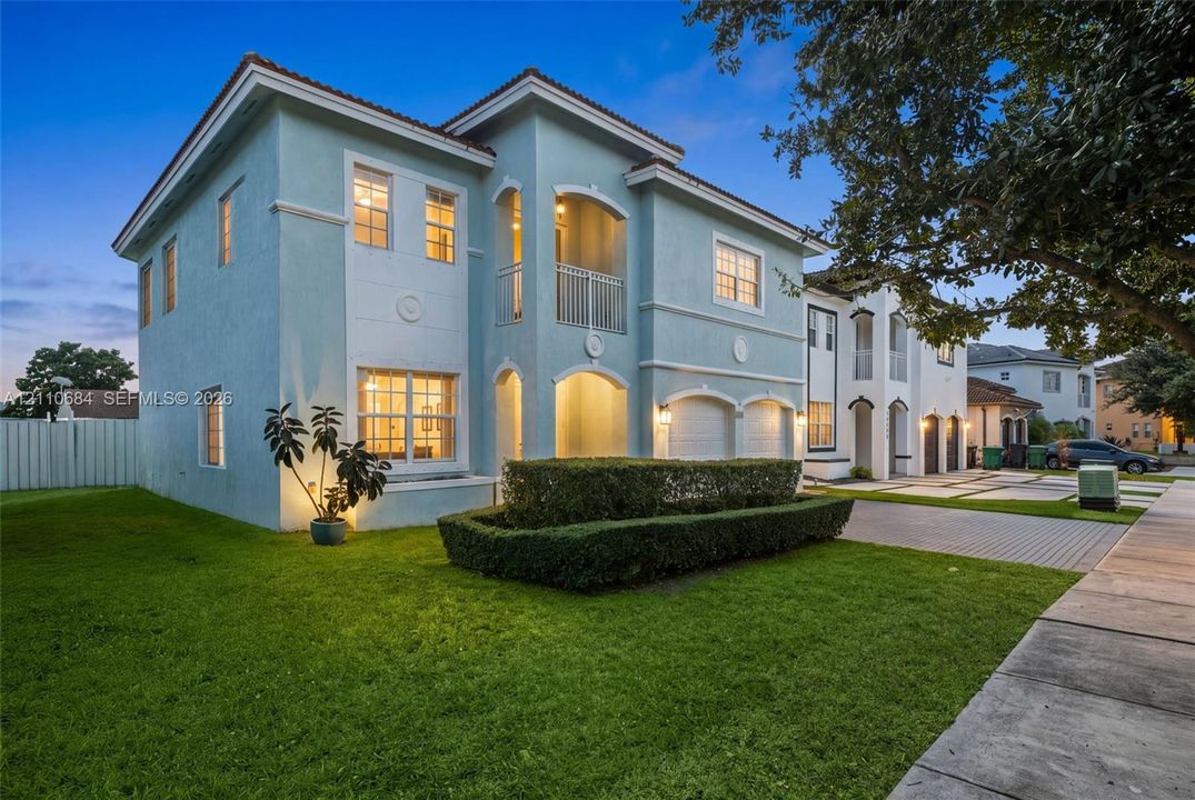 Two-story exterior,  balcony, a 2-car garage, and a paver-stone driveway