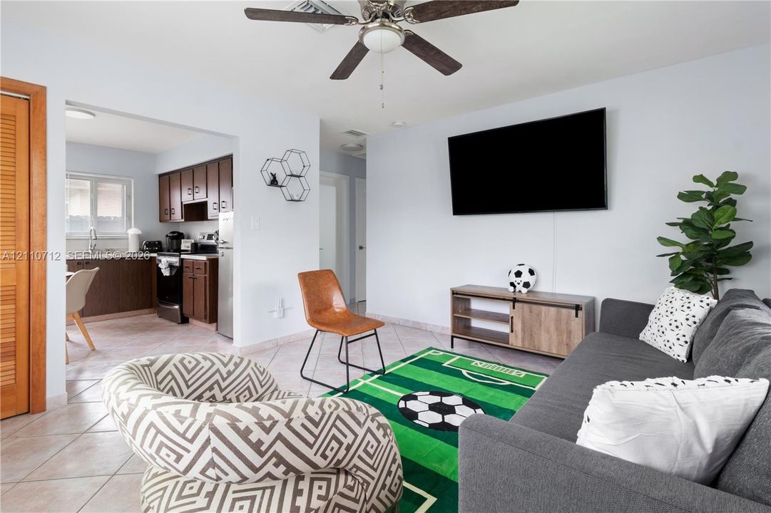 Interior space featuring neutral wall tones, ceramic tile flooring, and a ceiling fan
