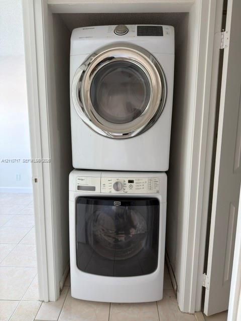 Stacked, front-loading washer and dryer unit housed in a dedicated closet