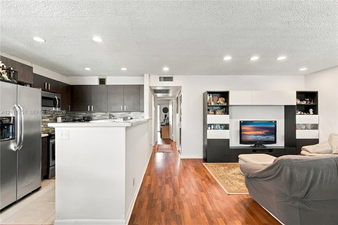 Kitchen featuring dark cabinetry, stainless steel appliances, and a mosaic tile backsplash