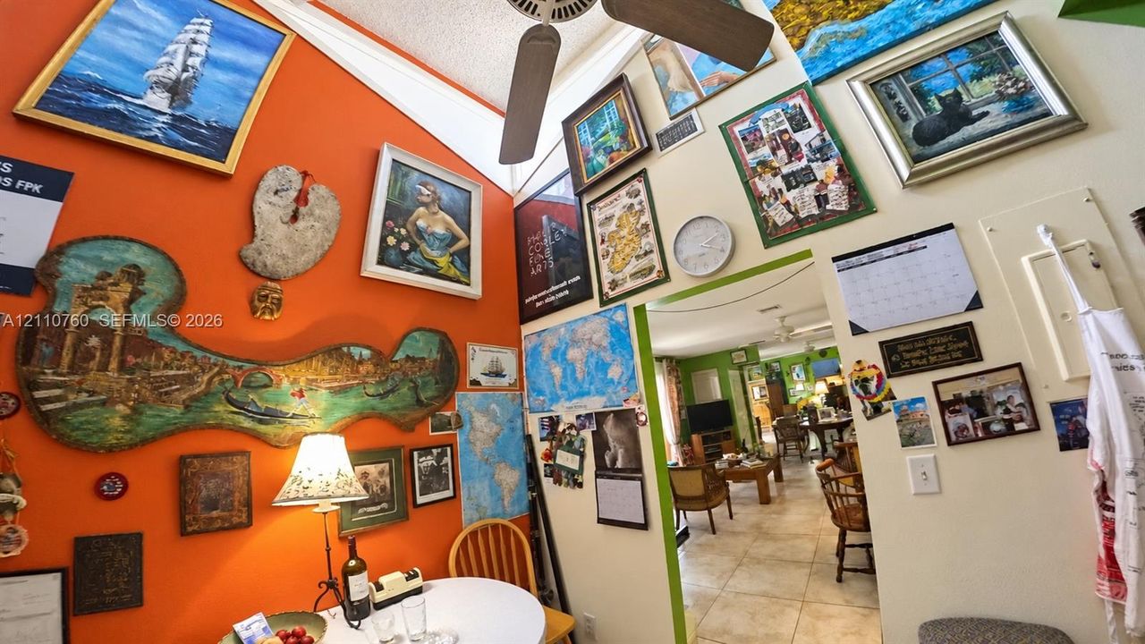Vaulted ceiling with a centrally mounted ceiling fan and large-format tile flooring