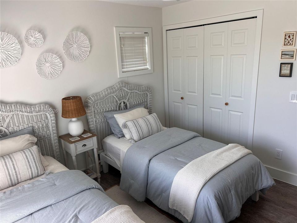 Neutral wall finish, double-panel closet doors, and wood-finish flooring