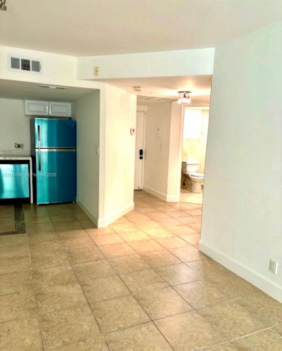 Tile flooring, built-in kitchen cabinetry, and stainless-steel appliances
