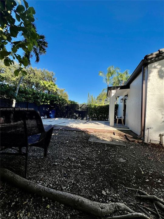Rear exterior space featuring a concrete patio, stucco siding, and perimeter privacy fencing