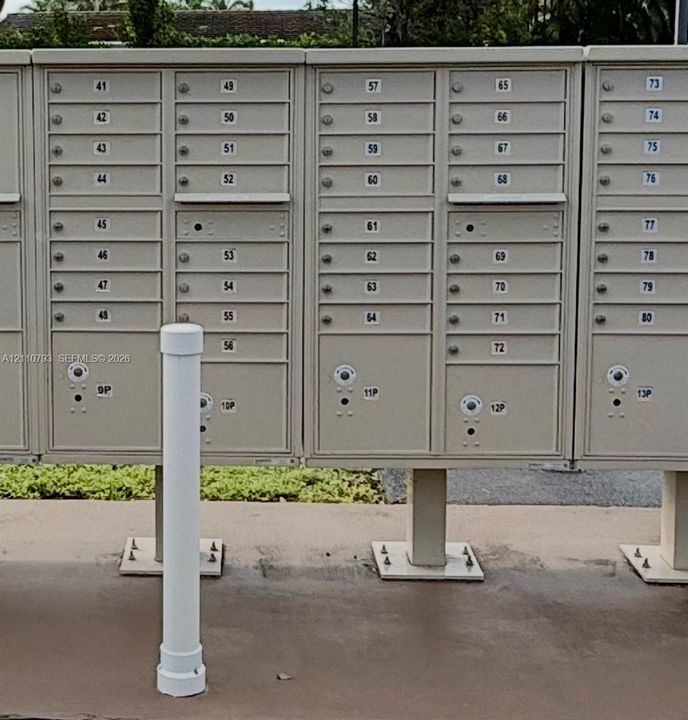 Wall-mounted, multi-unit metal cluster mailboxes featuring numbered compartments and integrated locks