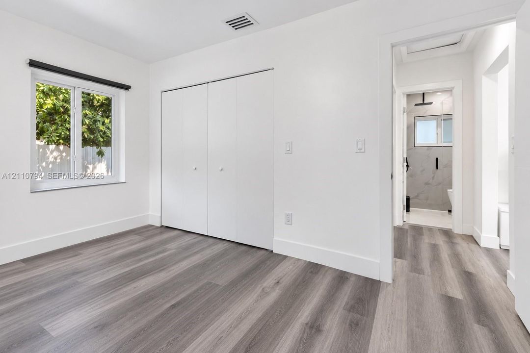 Wood-finish flooring, double-door reach-in closet, and single-hung window