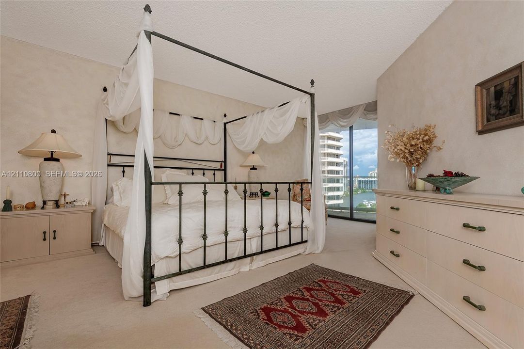 Neutral interior space featuring floor-to-ceiling glass sliding doors, wall-to-wall carpeting, and neutral textured wall finishes