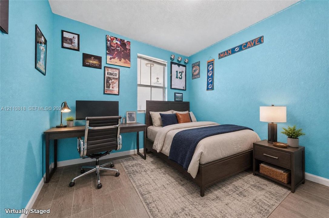 Bedroom featuring wood-finish flooring and a single-hung window