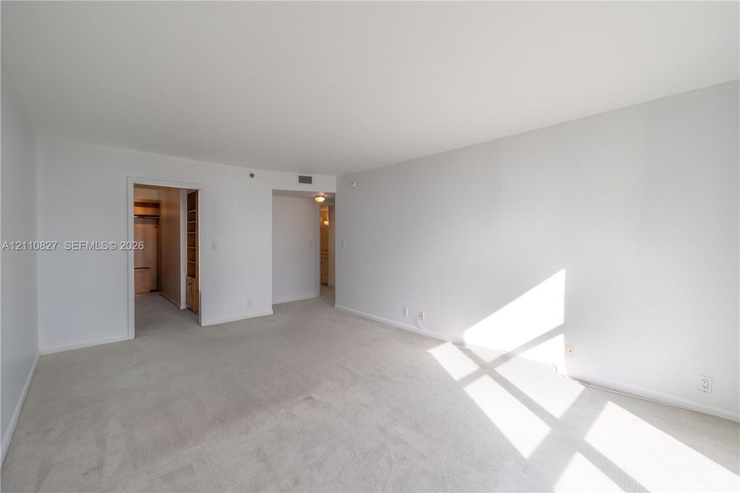 Neutral-toned wall paint, neutral carpeting, and recessed ceiling lighting