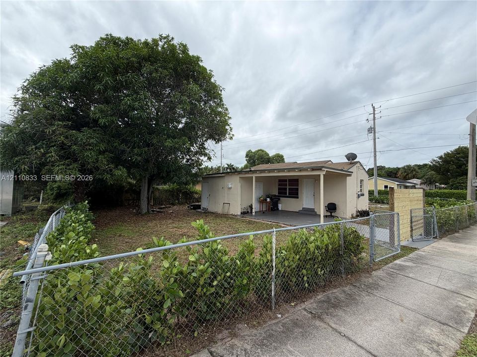 Charming single-story home with a covered front porch and open-air carport