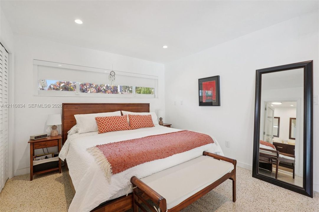 Bedroom featuring recessed lighting, horizontally oriented clerestory windows, and light-toned terrazzo flooring