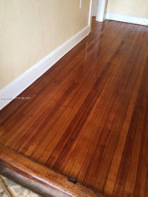 Polished wood-finish flooring featuring natural grain patterns and a wide-plank aesthetic